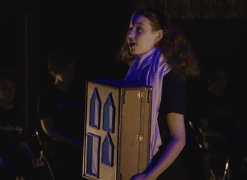 Spacebridge gif of girl holding prop and